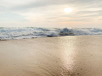 Scenic view of beach against sky during sunset