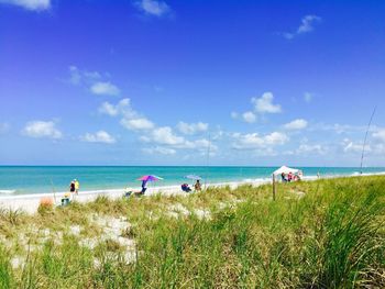 Scenic view of beach against blue sky