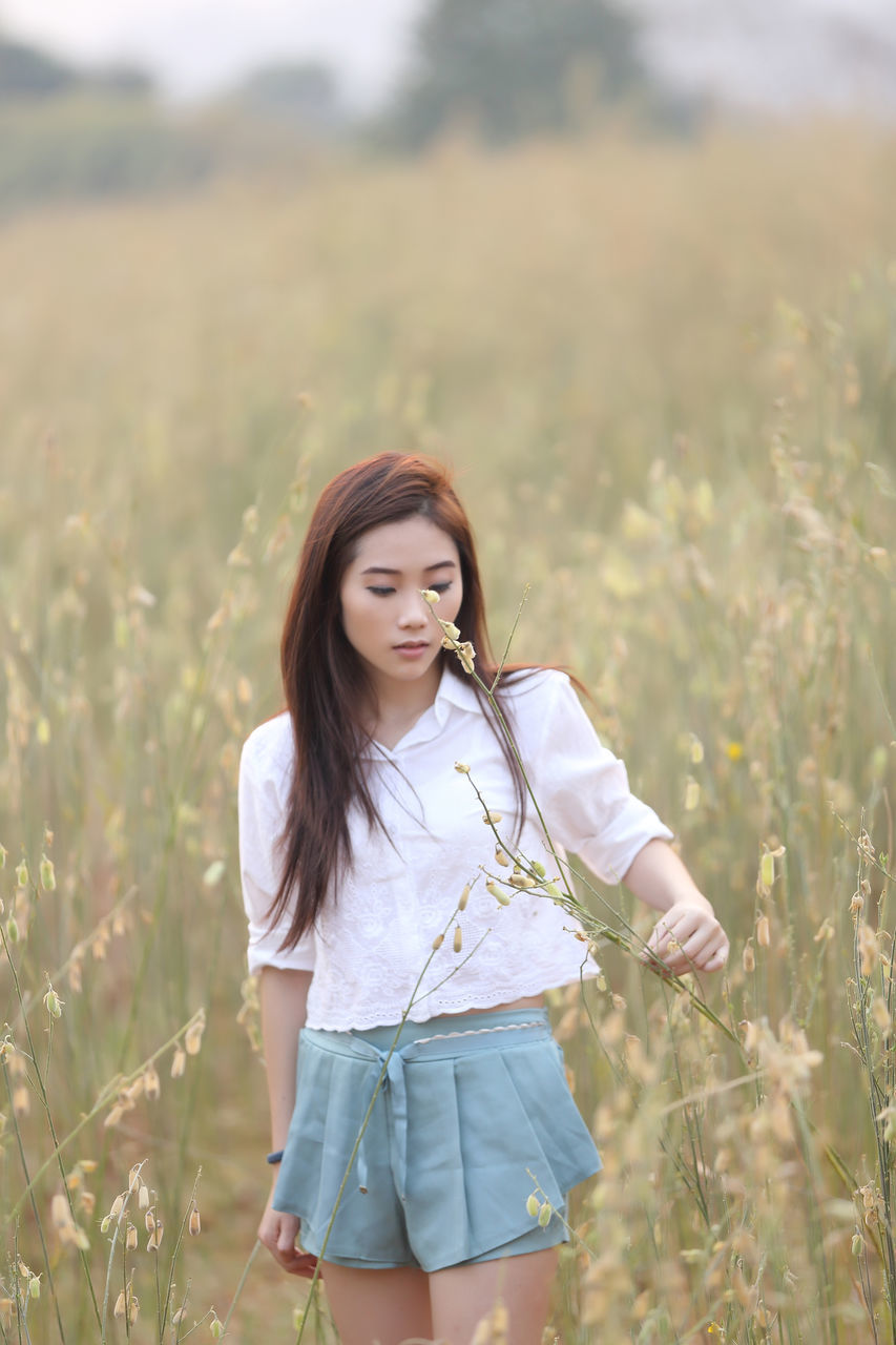 WOMAN STANDING ON FIELD