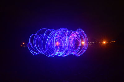 Light painting against blue sky at night