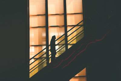 Shadow of person holding window in dark room