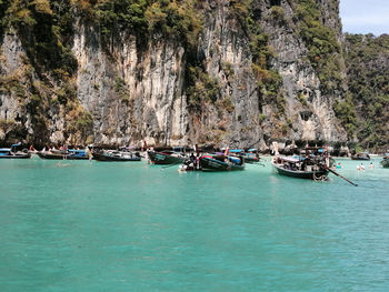 Sailboats moored on sea