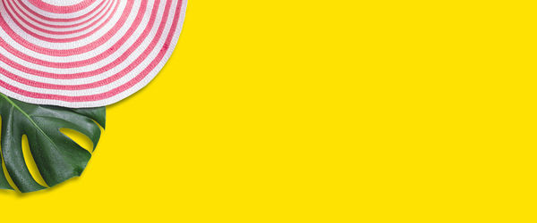 Low section of person standing on multi colored yellow background