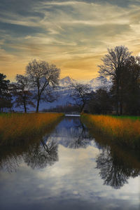 Scenic view of lake against sky during sunset