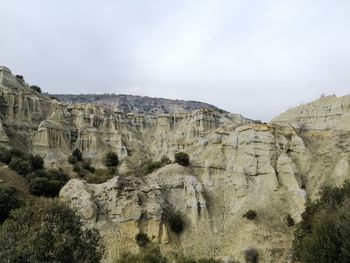 Panoramic view of rock formations against sky
