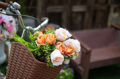 Close-up of rose bouquet in basket on table