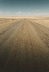 Empty road passing through land