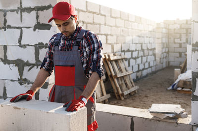 Side view of man working at construction site