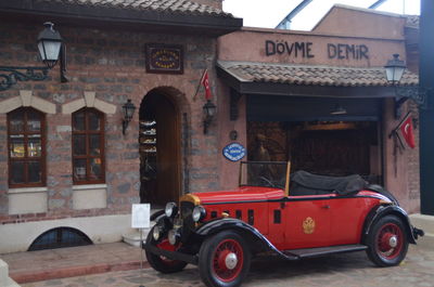 Car on street against buildings in city