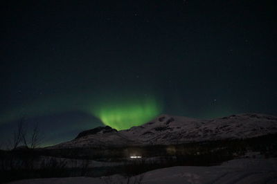 Scenic view of mountains against sky at night