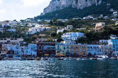 Boats in river with buildings in background