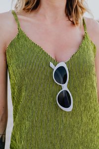 Midsection of woman with sunglasses on top
