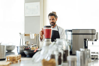 Young man preparing food in kitchen