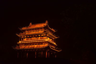 Low angle view of illuminated temple against clear sky at night