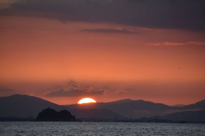 Scenic view of sea against romantic sky at sunset