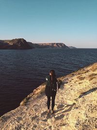 Man standing on beach against clear sky