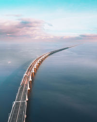 Aerial view of bridge over sea against sky