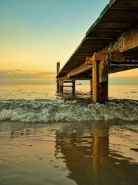 Scenic view of pier on sea against sky during sunset