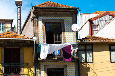 Low angle view of clothes drying on building against sky