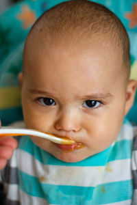 Close-up portrait of cute boy eating ice cream