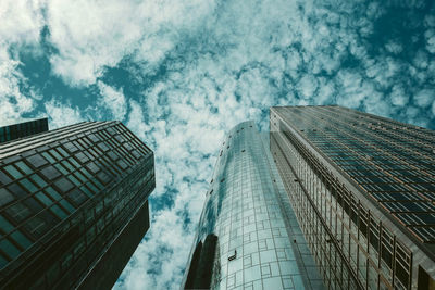 Low angle view of modern glass building against sky