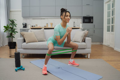 Portrait of young woman exercising in gym