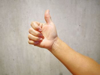 Close-up of person hand against wall