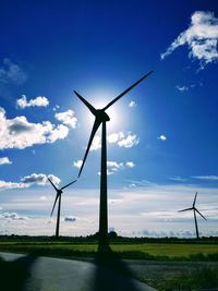 Windmill on field against sky