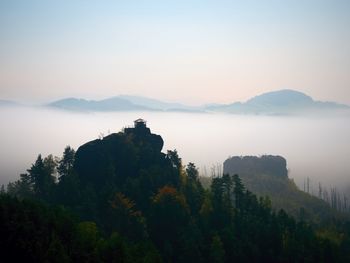 Scenic view of tree mountains against sky