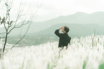 Full length of man standing on land against sky
