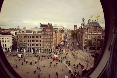 Panoramic view of people in city against sky