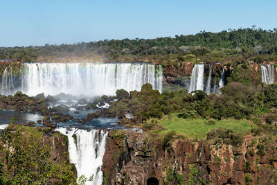 Scenic view of waterfall against sky