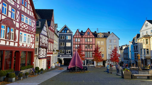 Buildings in city against blue sky