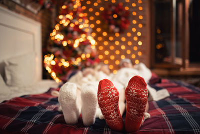 Close-up of christmas decorations at home, people and their christmas socks 