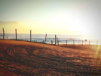 Scenic view of beach against sky during sunset