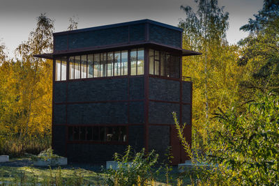 Low angle view of house amidst trees in forest