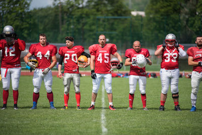 Group of people standing on grassland