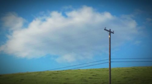 Low angle view of landscape against cloudy sky