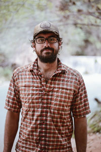 Portrait of hiker standing in forest