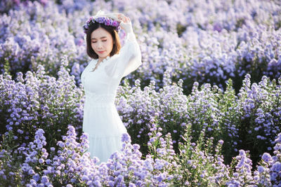 Portrait of a beautiful woman standing on field