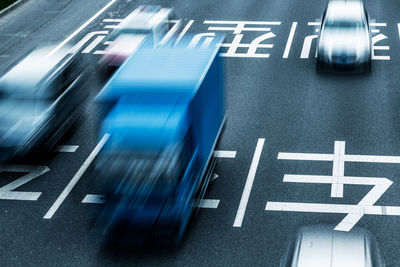 High angle view of sign on road in city