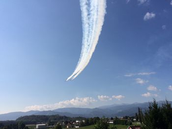 Low angle view of airplane flying against sky