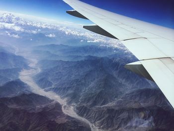 Cropped image of airplane flying over landscape