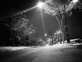 View of illuminated street during winter at night