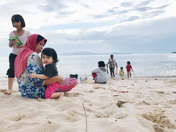 Friends sitting on beach