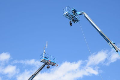 Low angle view of crane against sky