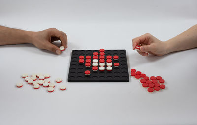 High angle view of people holding hands over white background