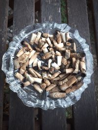 Close-up of burnt cigarettes in ashtray on table