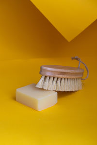 High angle view of soap and brush on table
