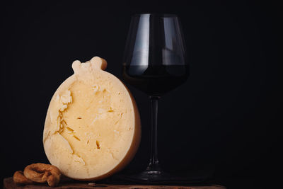 Close-up of beer glass on table against black background